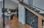 LIVING AREA ENTRANCE w/STAIRCASE WINE RACK